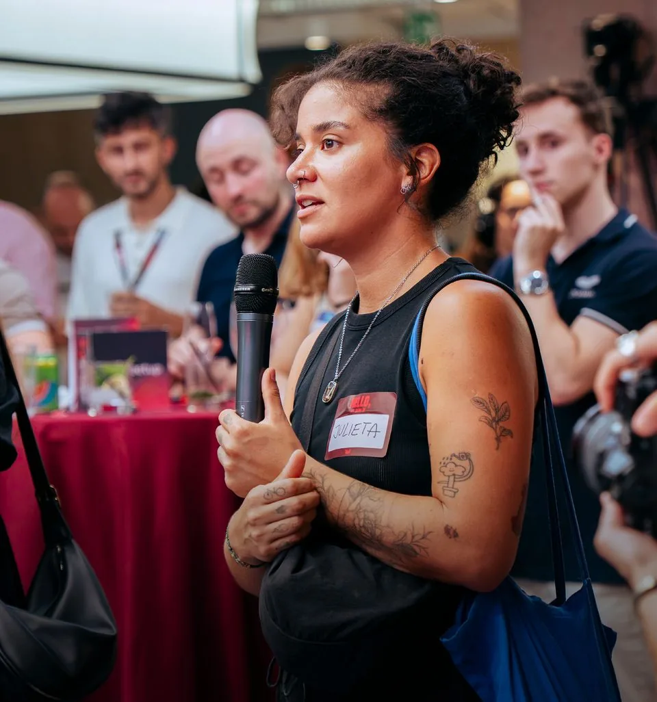 An attendee holding a microphone, asking a question from the floor.